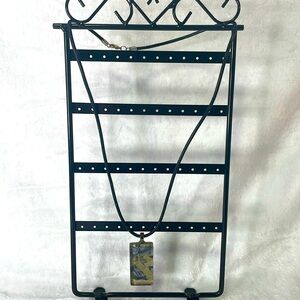 Art deco gold and blue glass pendant on leather strap.